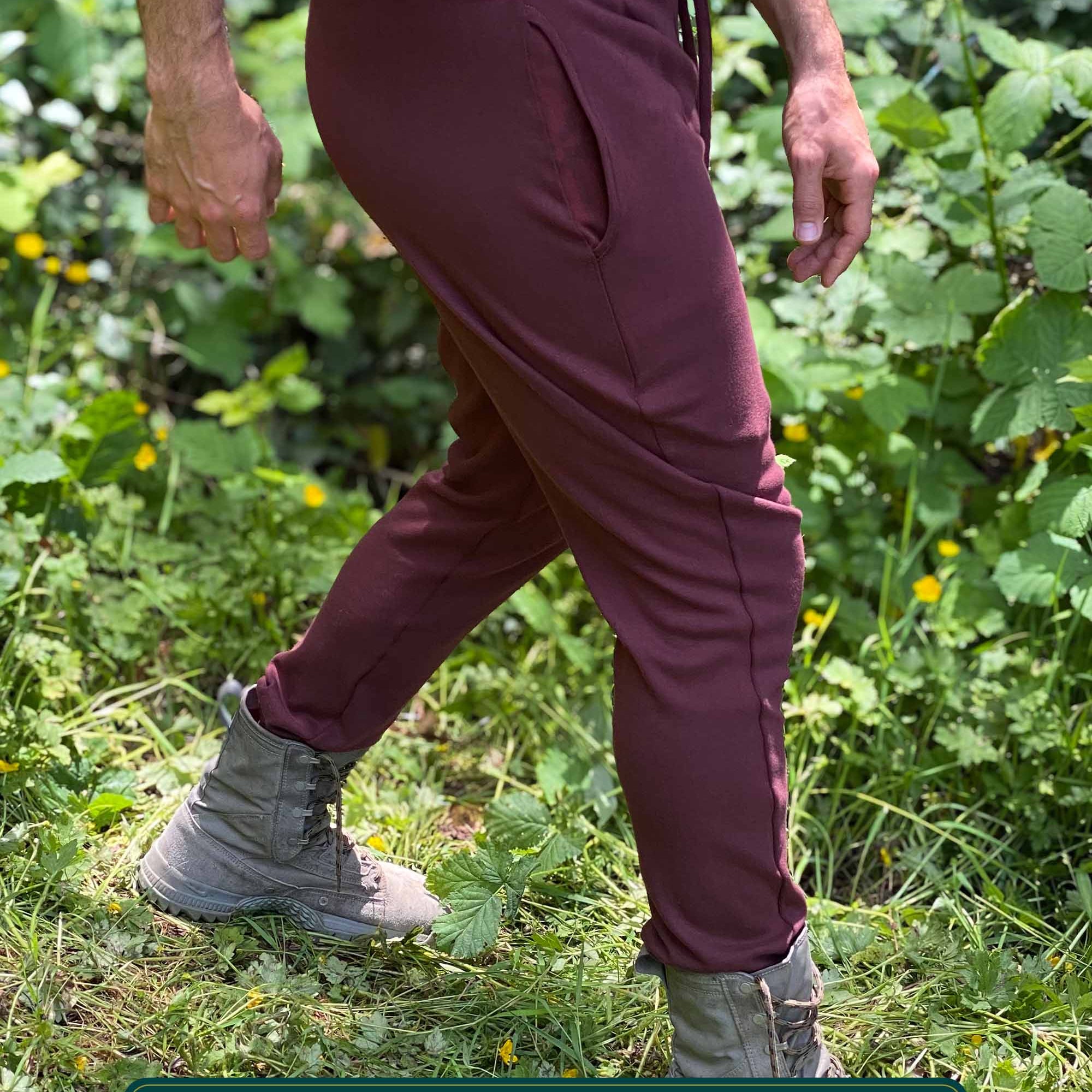 Organic cotton unisex joggers, reddish brown fabric, right side view on male model.