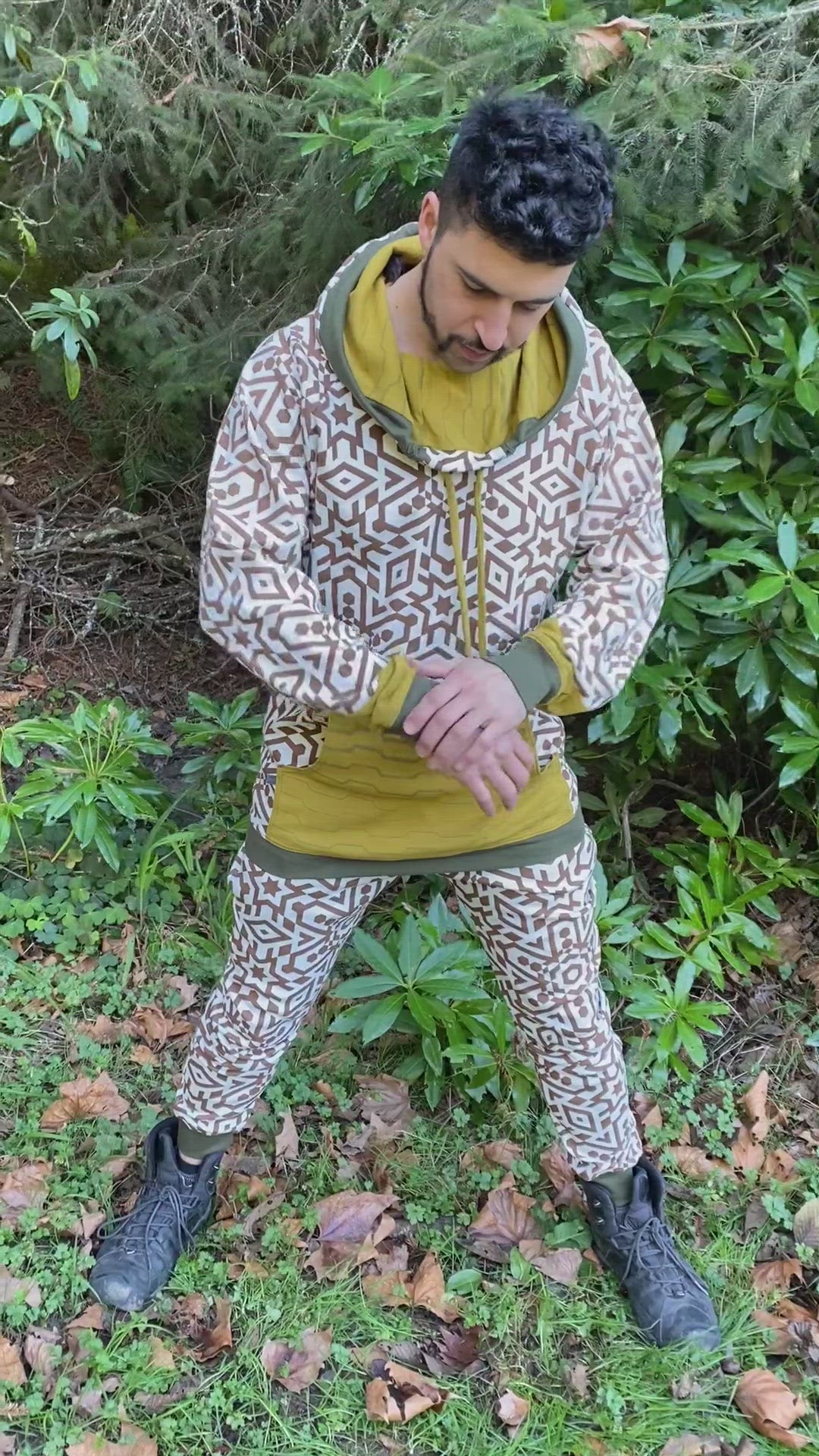 Men's matching two piece sweatsuit, geometric printed organic cotton fabric, worn on male model.