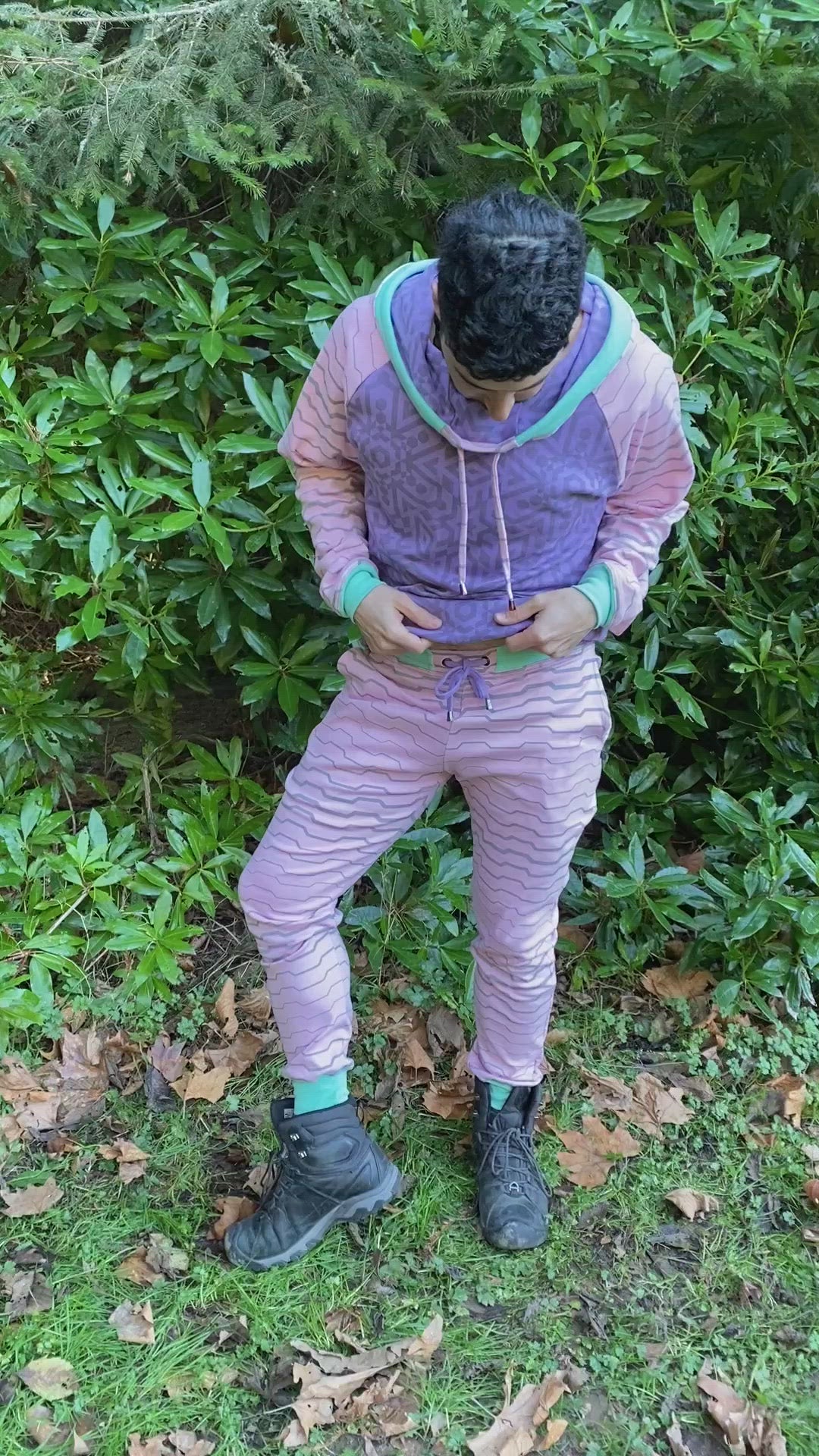 Men's matching two piece sweatsuit, purple and pink geometric printed organic cotton fabric, worn on male model.