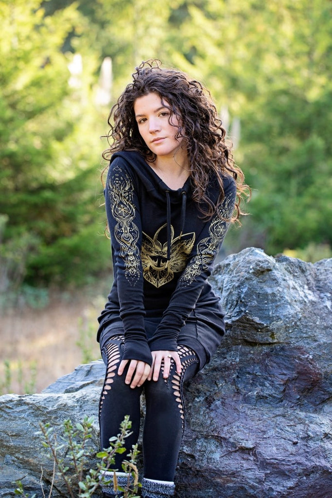 Black hooded dress with gold lotus flower print and pockets. Deep cowl hood. Organic cotton festival wear made in the USA.