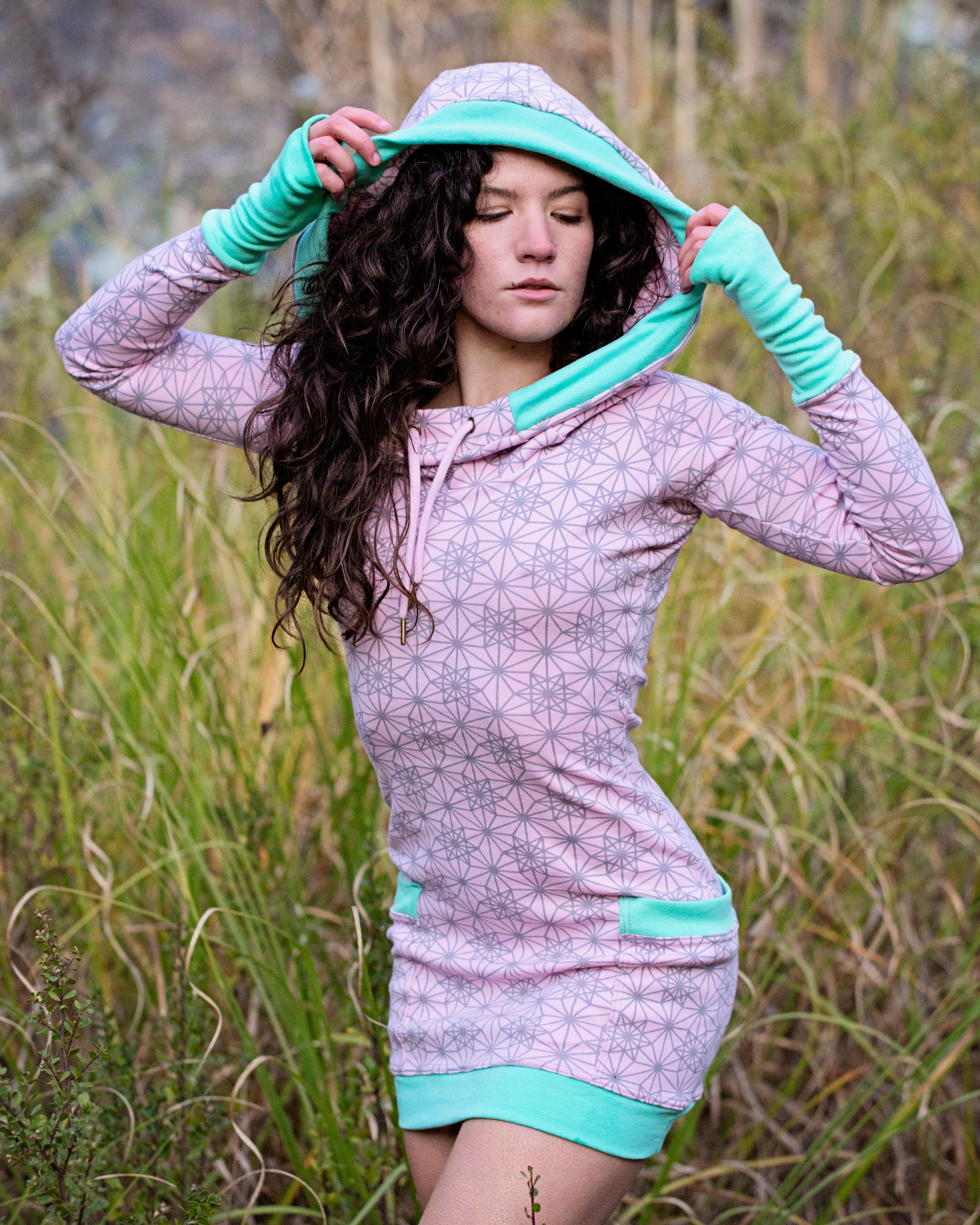 Pink hoodie dress with sacred geometry design. Deep drawstring hood. Festival wear made in the USA from organic cotton.