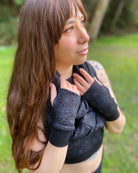 Organic cotton hand warmers and matching scarf in black fabric and geo print, right side view on female model.