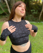 Organic cotton crop top and matching hand warmers in black fabric and geometric print, on female model.
