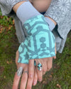 Organic cotton hand warmers mint colored fabric with geometric print, top detail view.