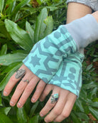 Organic cotton hand warmers mint colored fabric with geometric print, top detail view in nature.