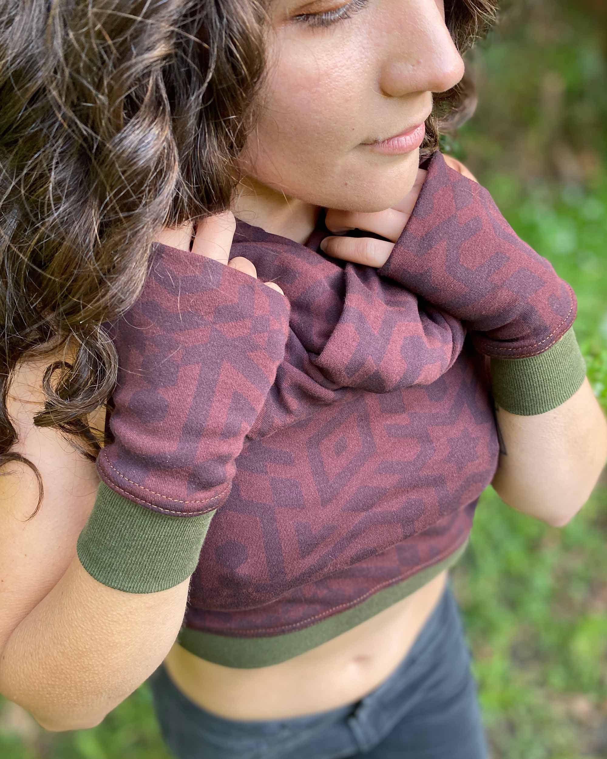 Organic cotton hand warmers and crop top in reddish brown colored fabric with geometric print and green accents.