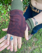 Organic cotton fingerless gloves in reddish brown colored fabric with geometric print, left hand view.