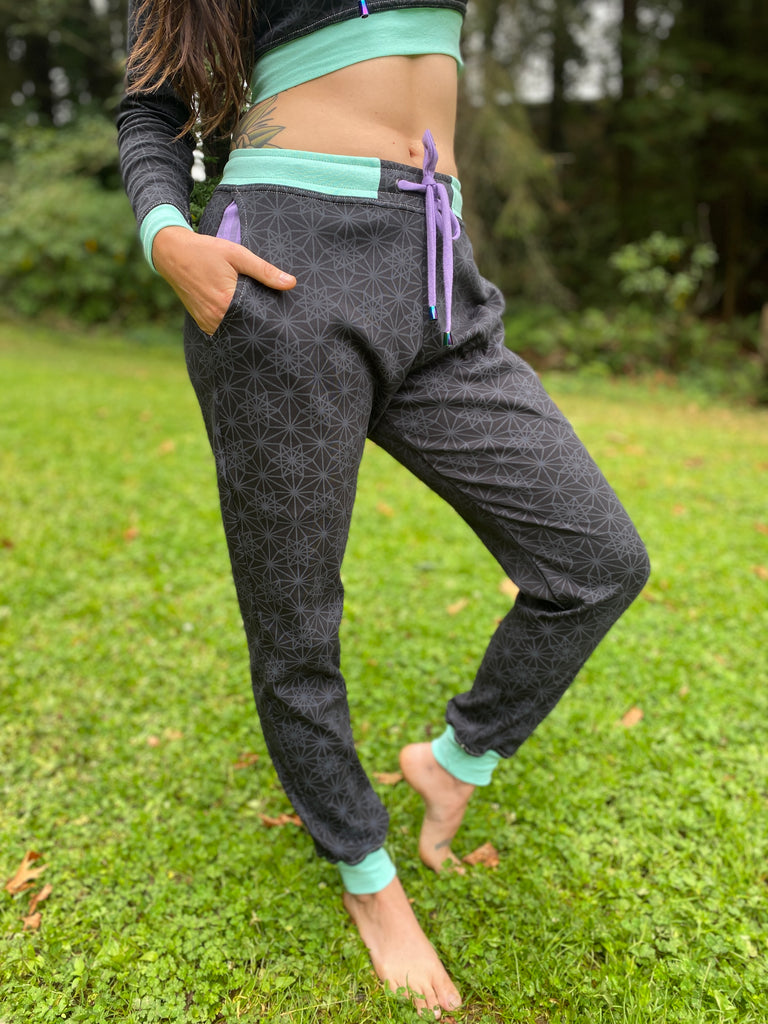 Unisex black joggers with Purple drawcord and seafoam color accents. Sacred Geometry Screen Printed Fabric made in the USA with organic cotton.