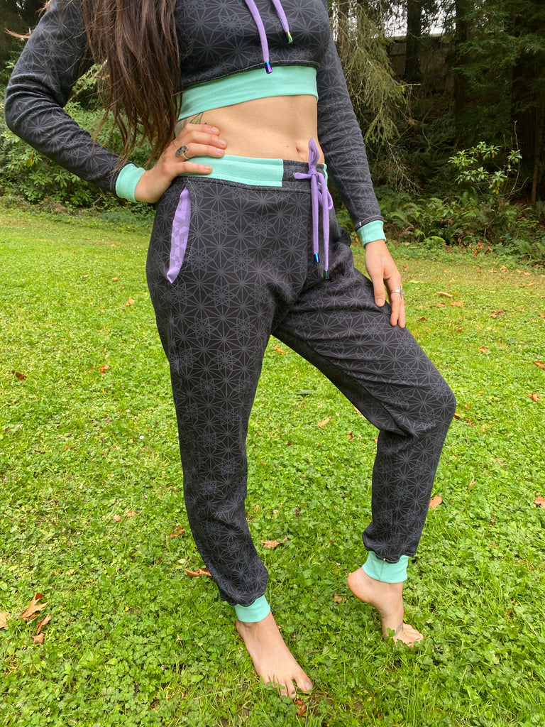 Unisex black joggers with Purple drawcord and seafoam color accents. Sacred Geometry Screen Printed Fabric made in the USA with organic cotton.