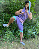 Organic cotton hooded tank top and shorts, lavender fabric with geometric print, full body view on male model.