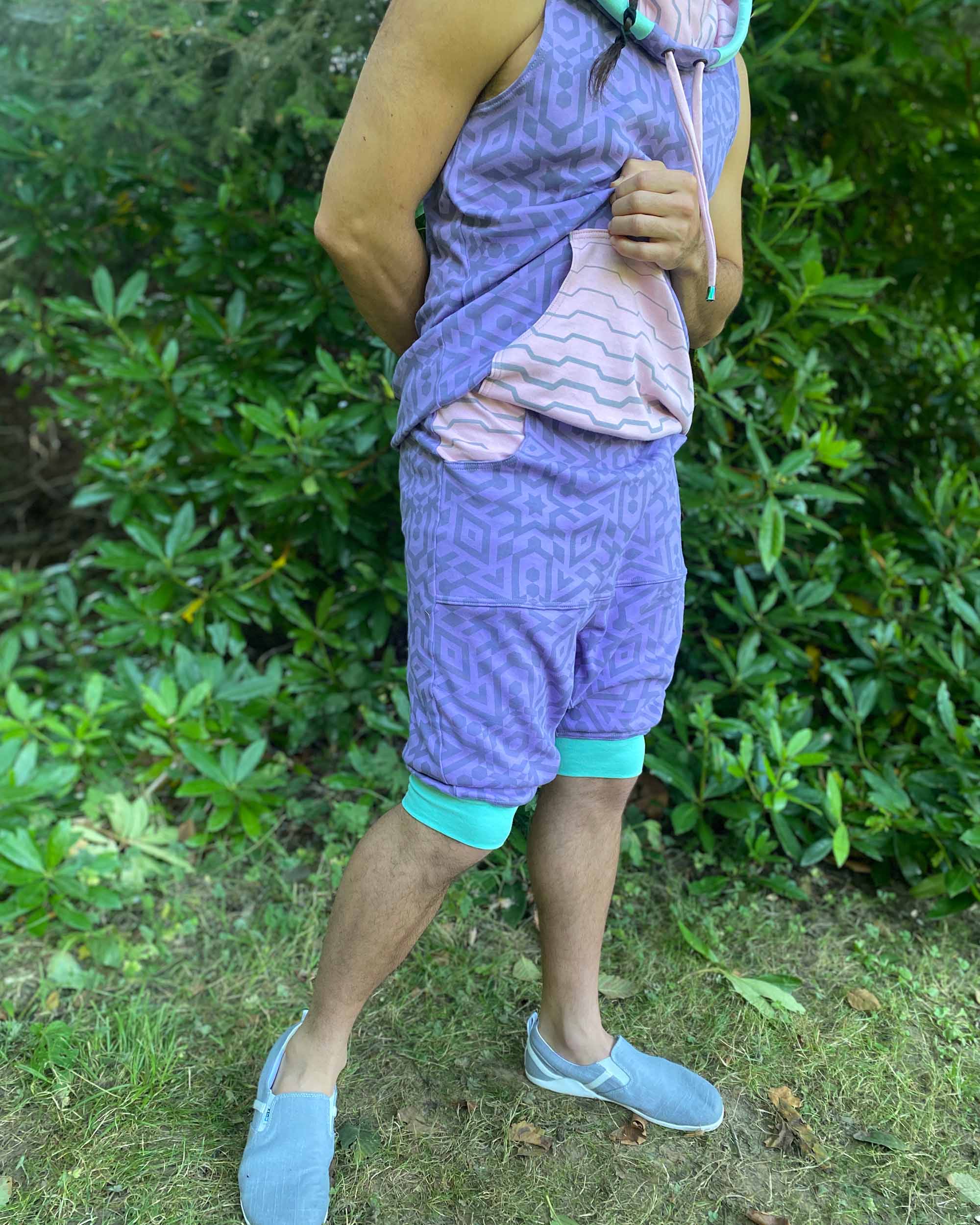 Organic cotton hooded tank top and shorts, lavender fabric with geometric print, right side view on model.