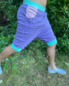 Organic cotton hooded tank top and shorts, lavender fabric with geometric print, side view on model.