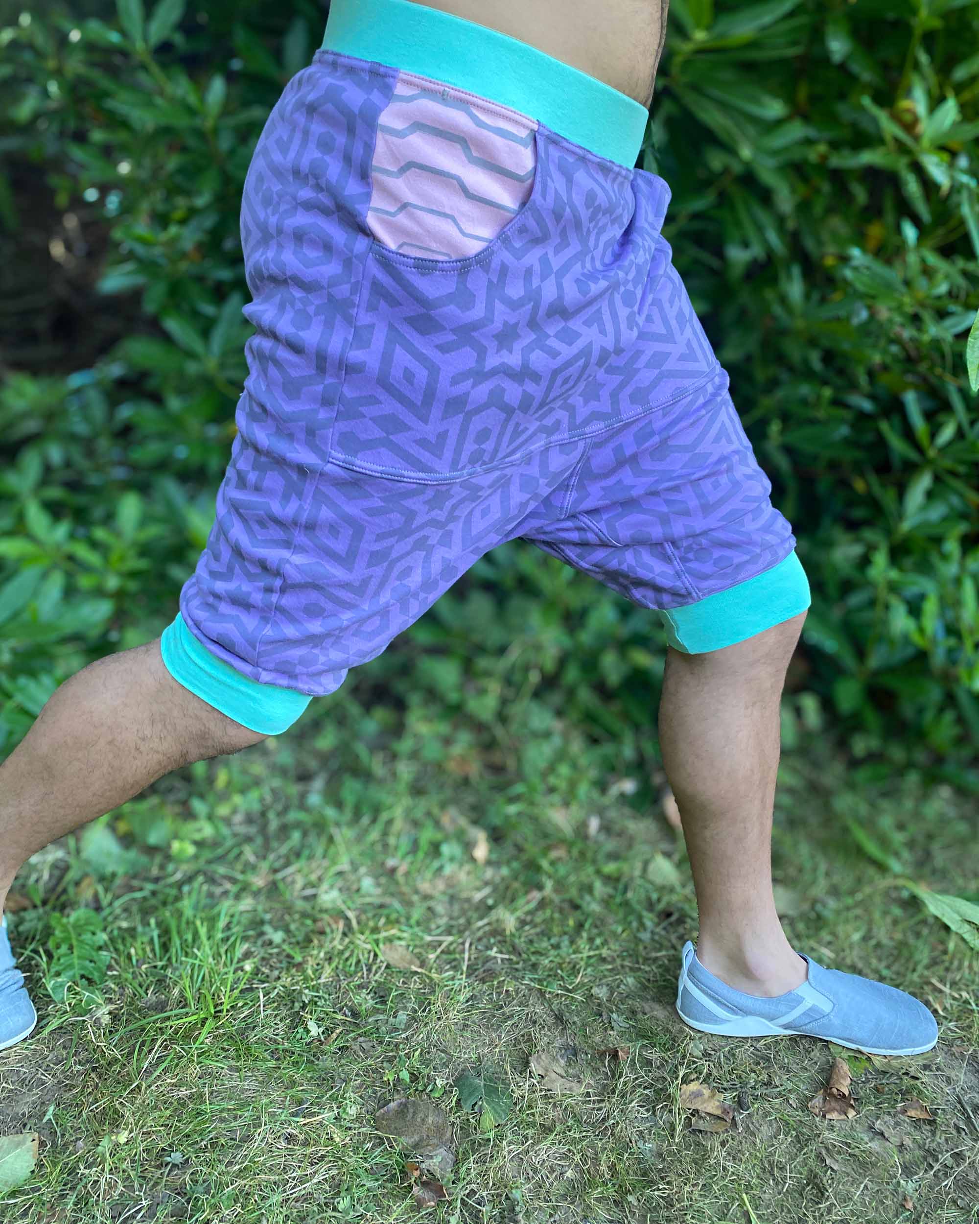 Organic cotton hooded tank top and shorts, lavender fabric with geometric print, side view on model.