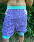 Organic cotton drop crotch shorts, lavender fabric with geometric print, detail view of the fabric.
