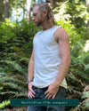 Organic cotton mens tank top, un-dyed fabric, left side view, on model in nature.