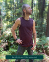 Organic cotton mens tank top, brown fabric with geometric print, left side view with model in natural light.