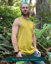 Organic cotton mens tank top, yellow fabric with geometric print, side view outdoors.