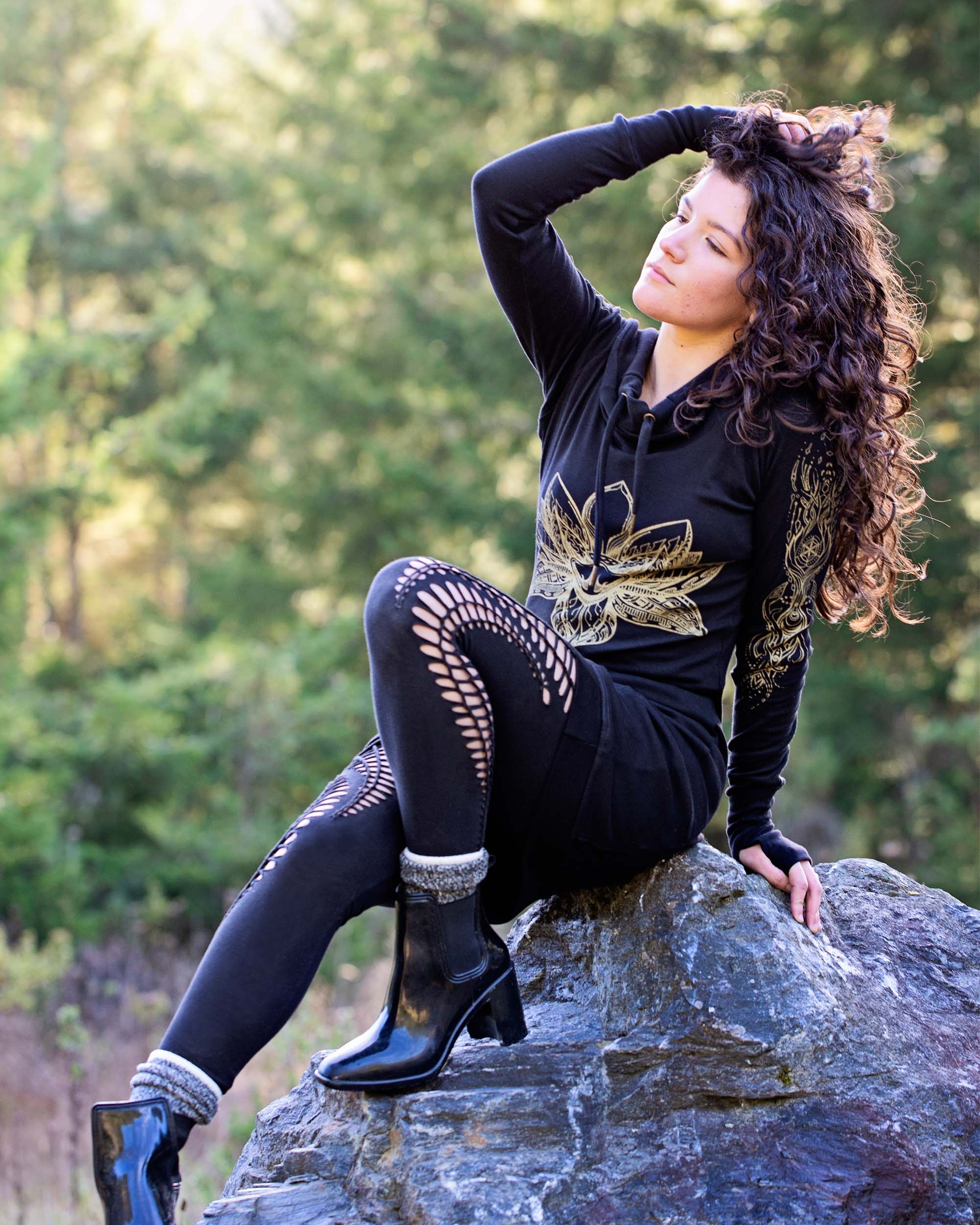 Organic cotton long sleeve tunic dress, black with front gold lotus print, side view on female model.