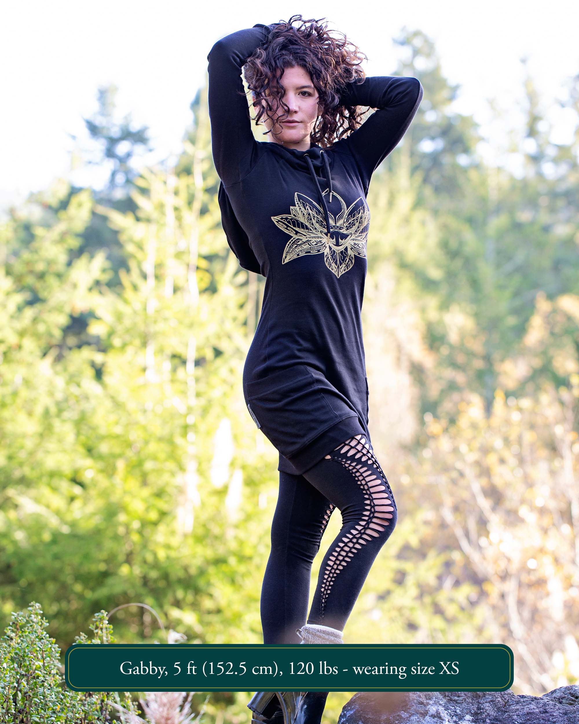Organic cotton long sleeve tunic dress, black with front gold lotus print, full length front view on female model.