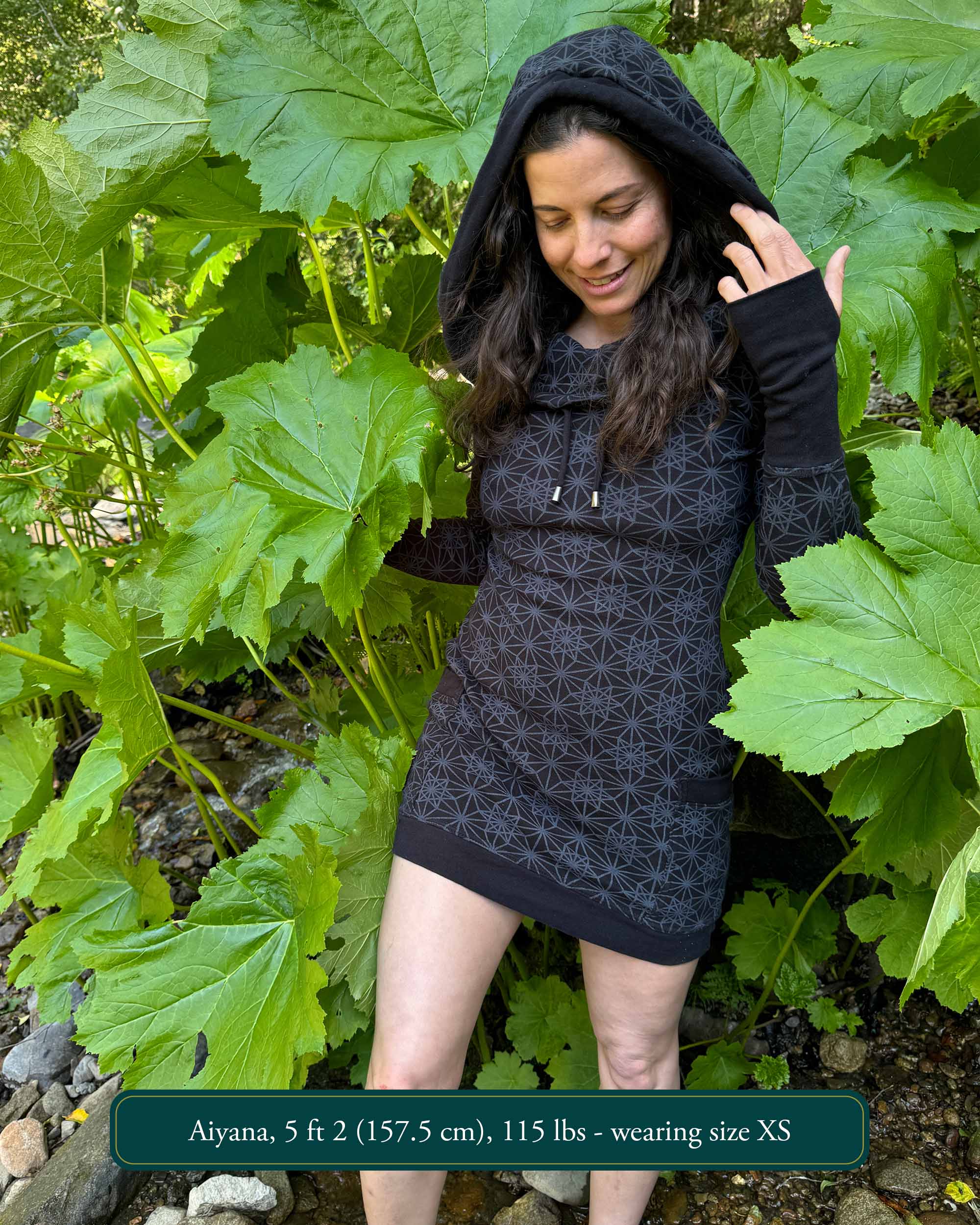 Organic cotton long sleeve tunic dress, black with sacred geometry print, front view on female model.