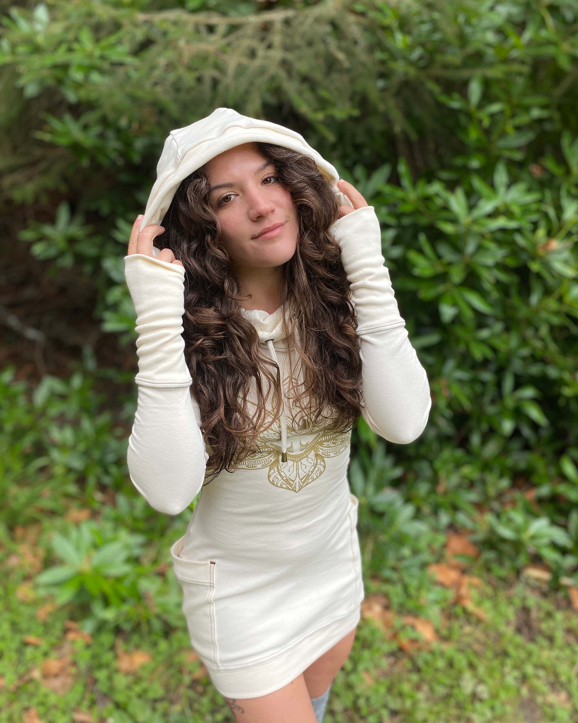 Organic cotton fitted tunic dress, undyed fabric with gold lotus design, front view worn by female model.