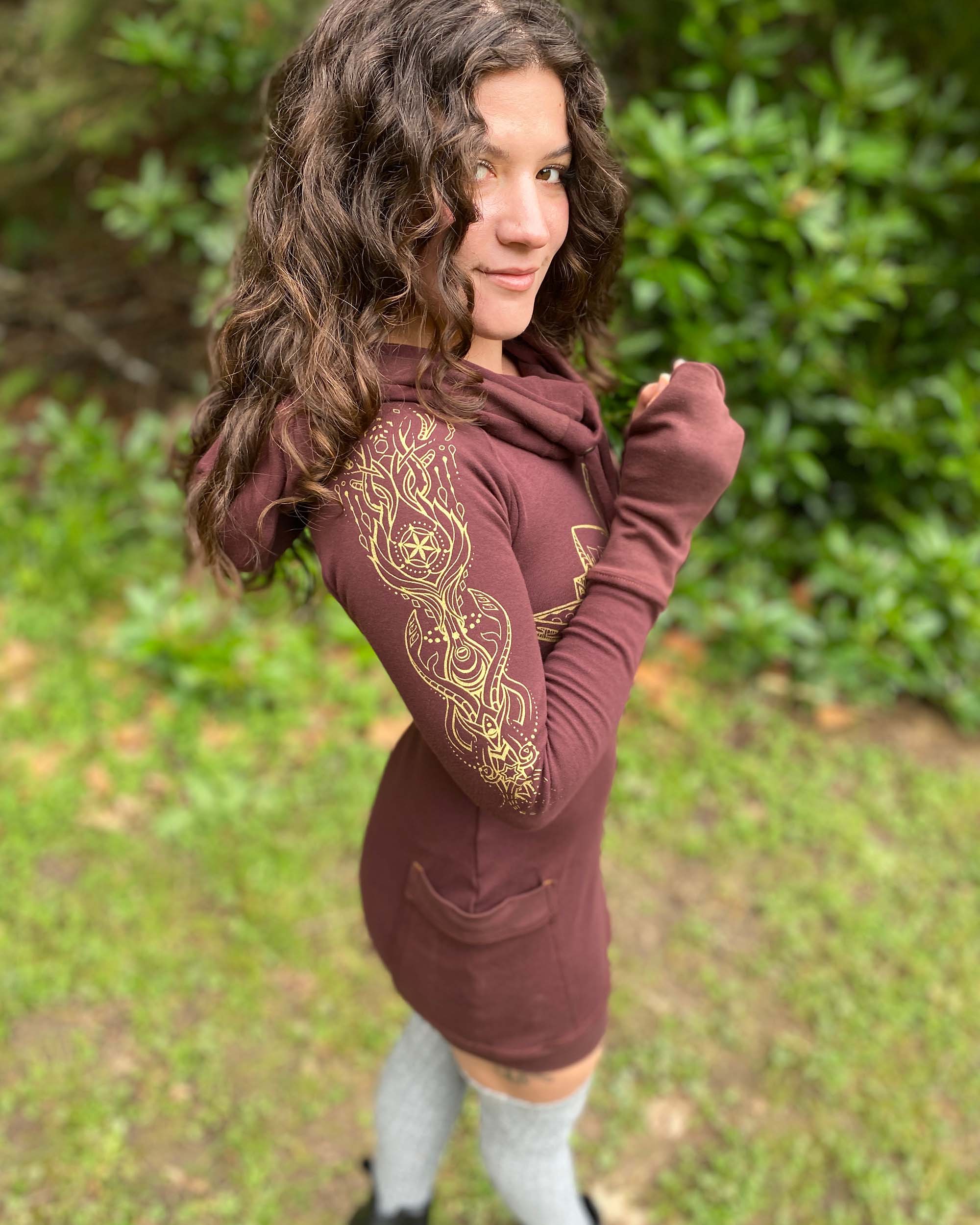 Organic cotton long sleeve tunic dress, brown with front gold lotus print, right side view on female model.
