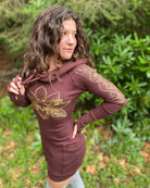 Organic cotton long sleeve tunic dress, brown with front gold lotus print, left side view on female model.