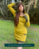 Organic cotton long sleeve tunic dress, yellow with green accent fabric, front view on female model.