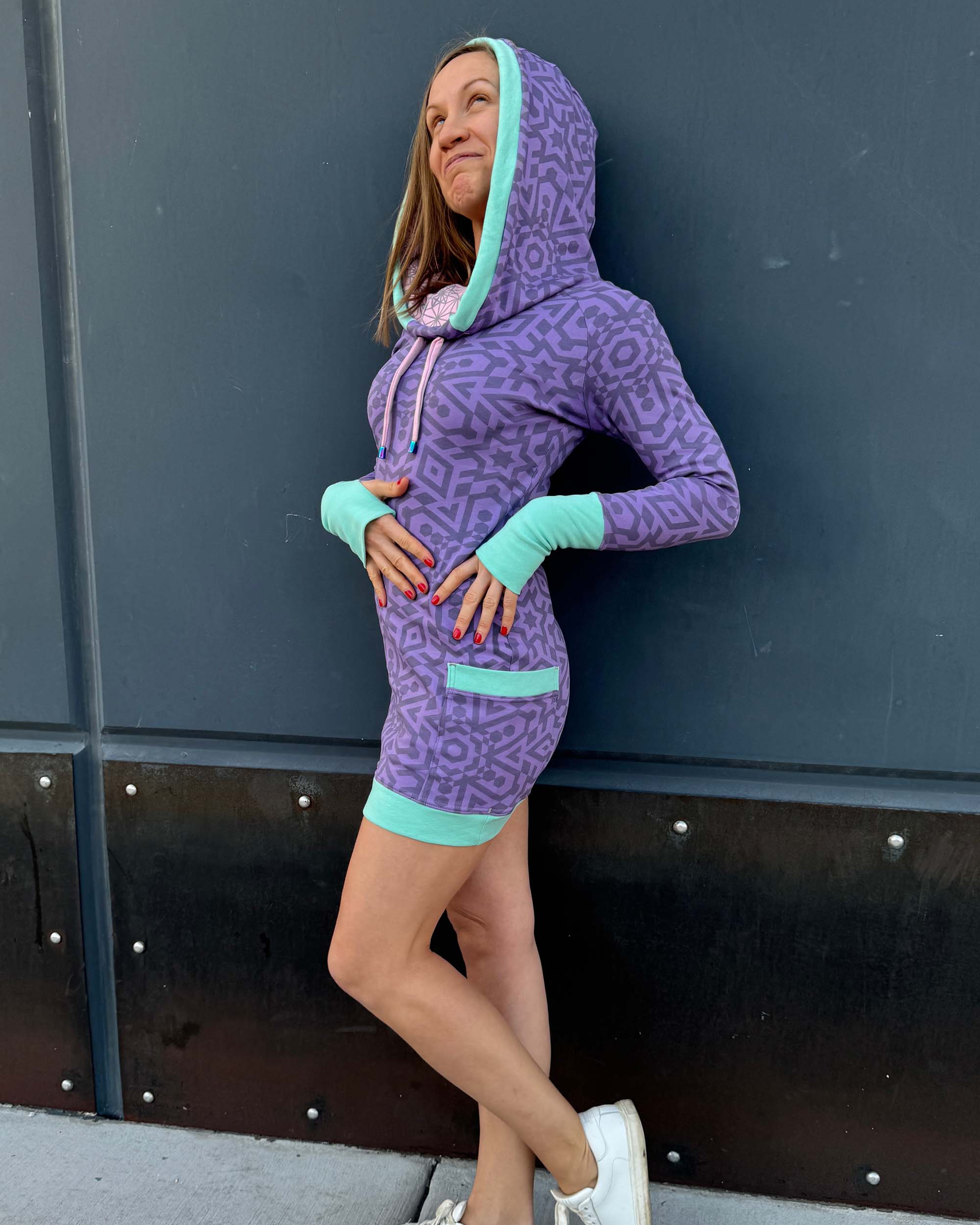 Organic cotton fitted tunic dress, lavender with geometric print with, left side view on female model.