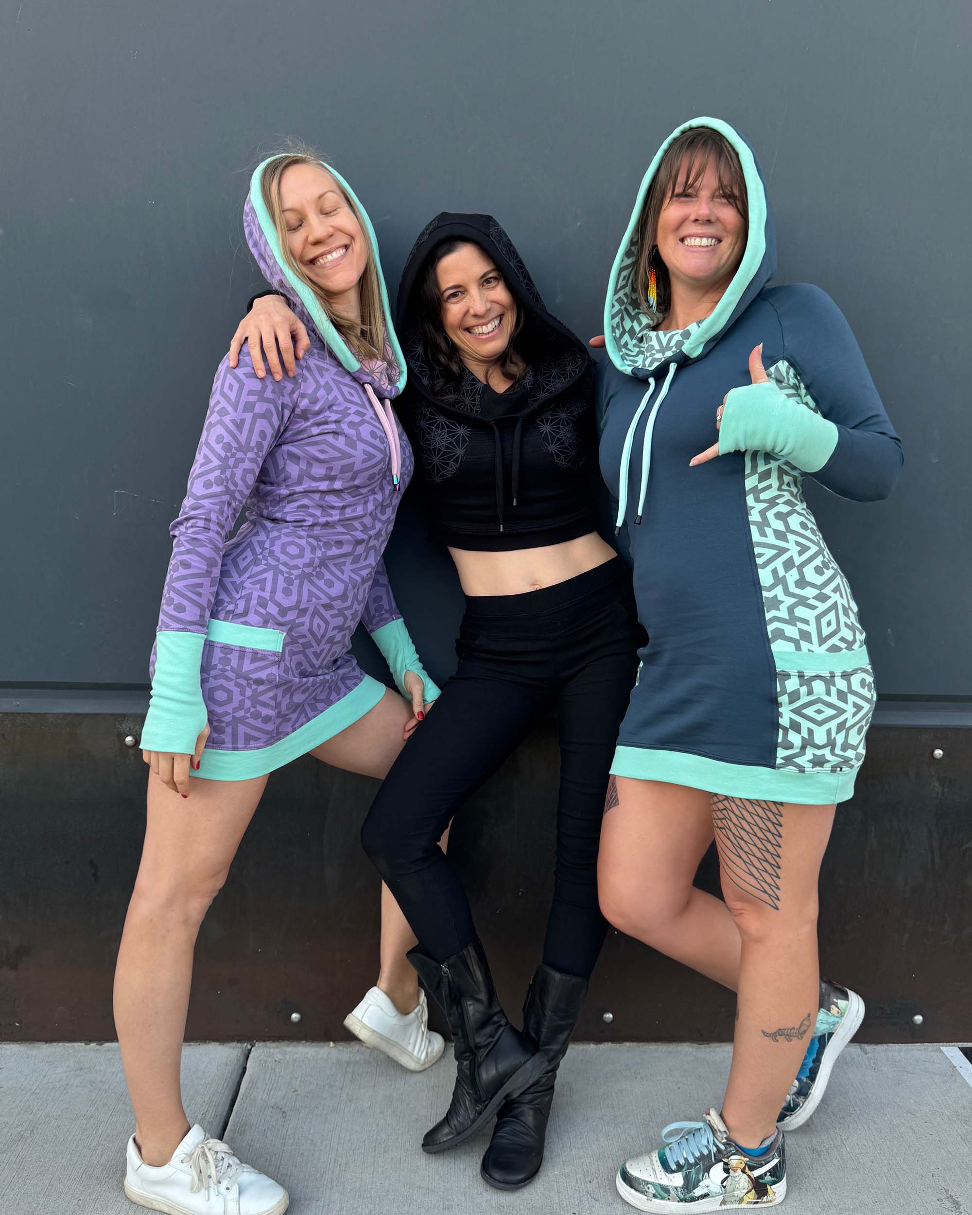3 models wearing organic cotton dresses in different color fabrics with matching geometric prints.