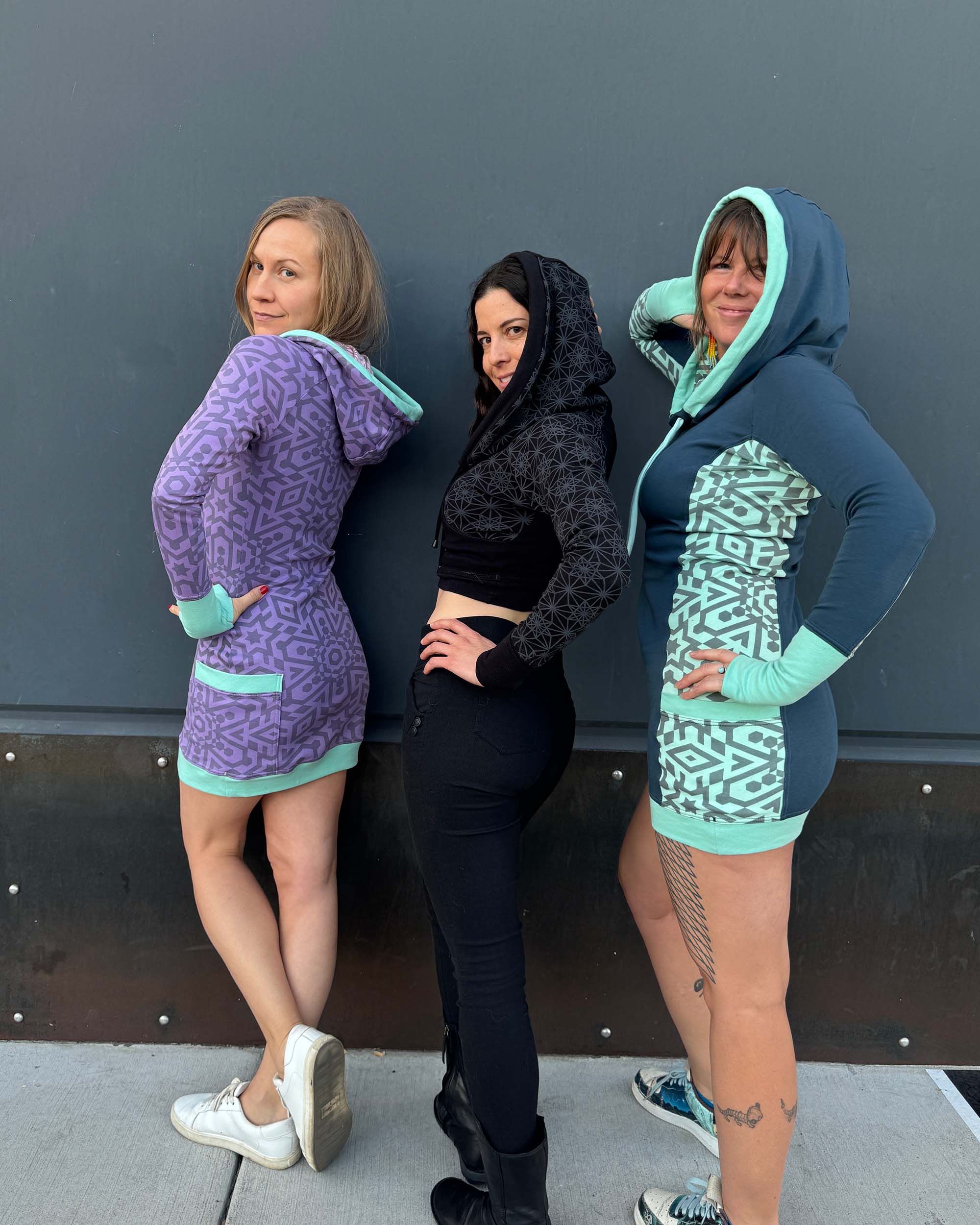 3 models wearing fitted tunic dresses in different color fabrics with matching geometric prints.