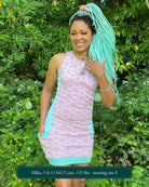 Organic cotton sleeveless dress, pink fabric with geometric print, front view on female model.