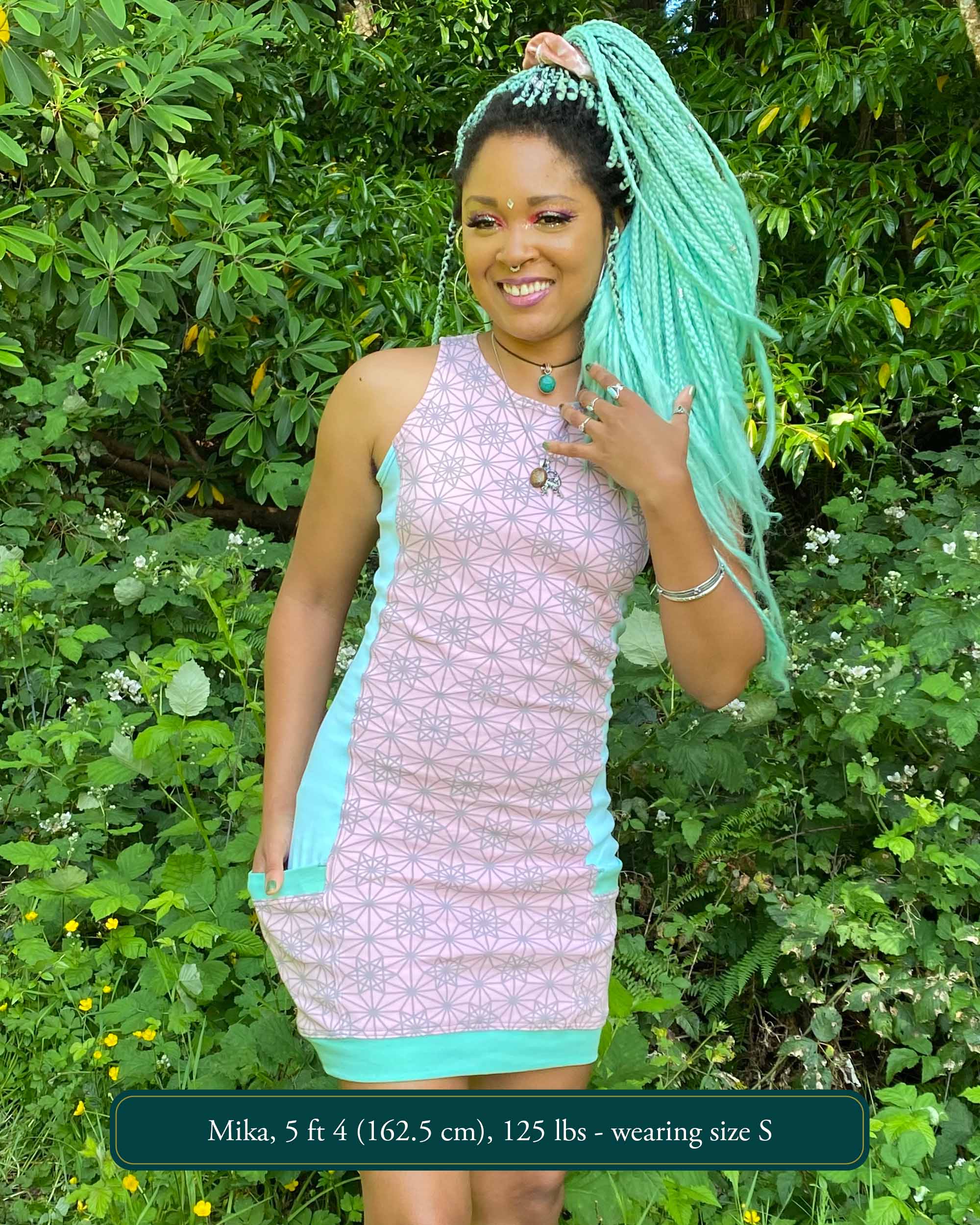 Organic cotton sleeveless dress, pink fabric with geometric print, front view on female model.
