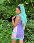 Lavender and pink sleeveless hooded dress, back side view worn by female model.