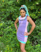 Lavender and pink sleeveless hooded dress, front view of female model in nature.