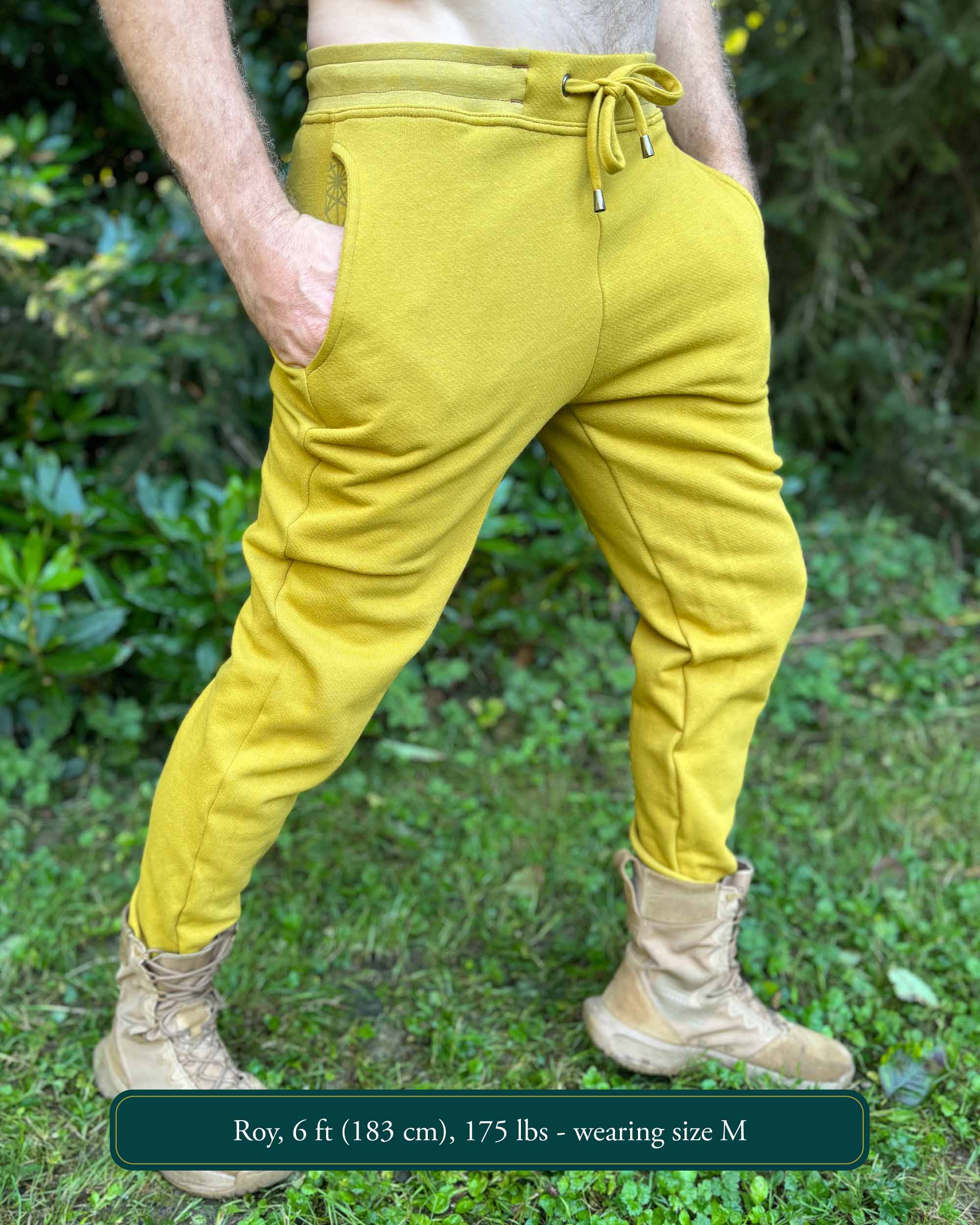 Organic cotton fleece joggers, solid yellow fabric, right side view on male model.