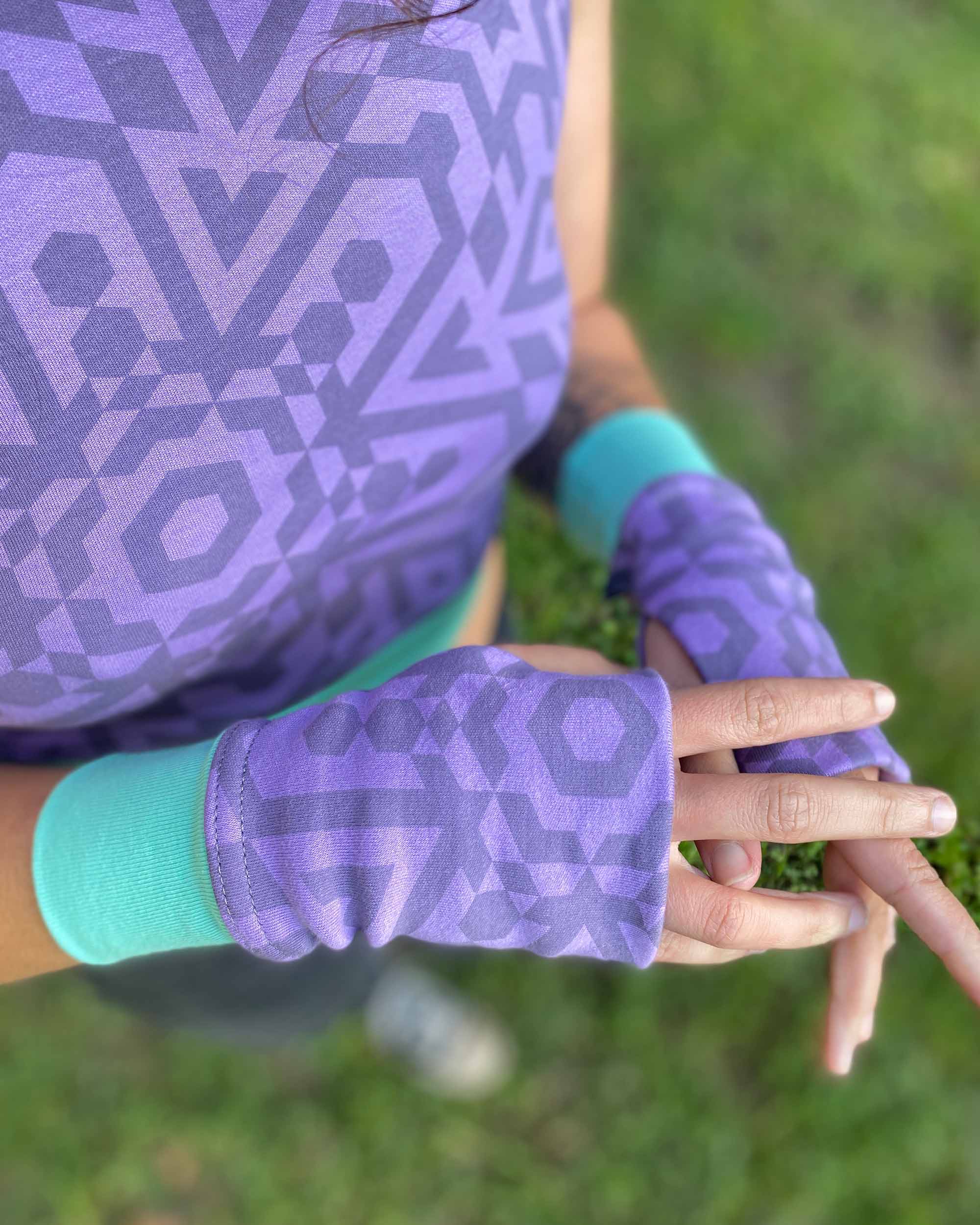 Organic cotton fingerless gloves in lavender fabric and geometric print, top detail view.
