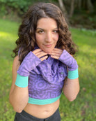 Organic cotton fingerless gloves in lavender fabric and geometric print, front view.