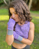 Organic cotton hand warmers, lavender fabric with geometric print, front view with female model.