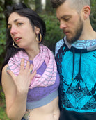 Pink organic cotton scarf with geometric stripes, front view on female model. 