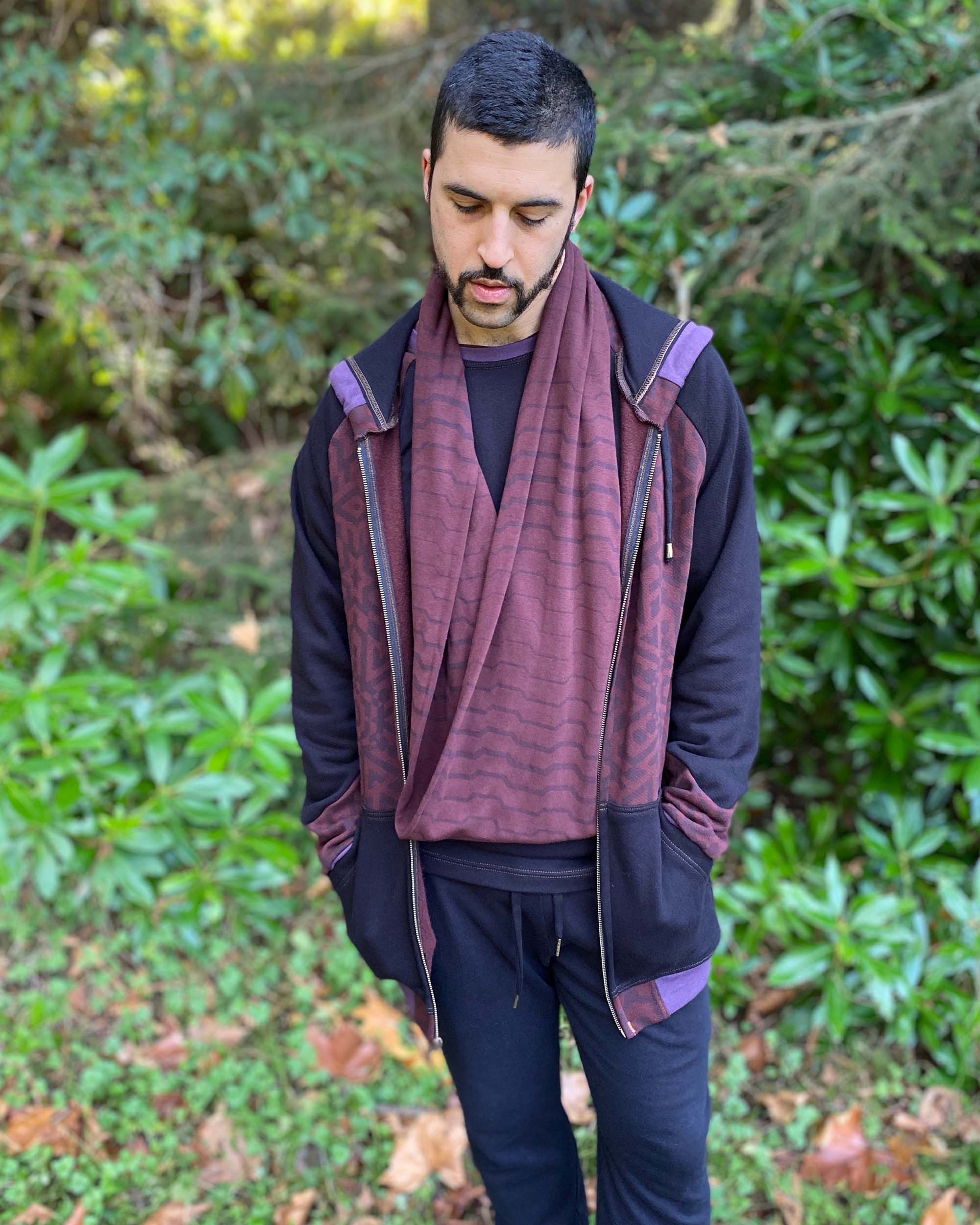 Organic cotton infinity scarf, brown fabric with geometric stripes, front view on male model. 