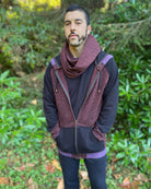 Organic cotton infinity scarf, brown fabric with geometric stripes, front view on male model in matching hoodie. 