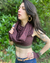 Organic cotton infinity scarf, brown fabric with sacred geometry print, right view on female model.