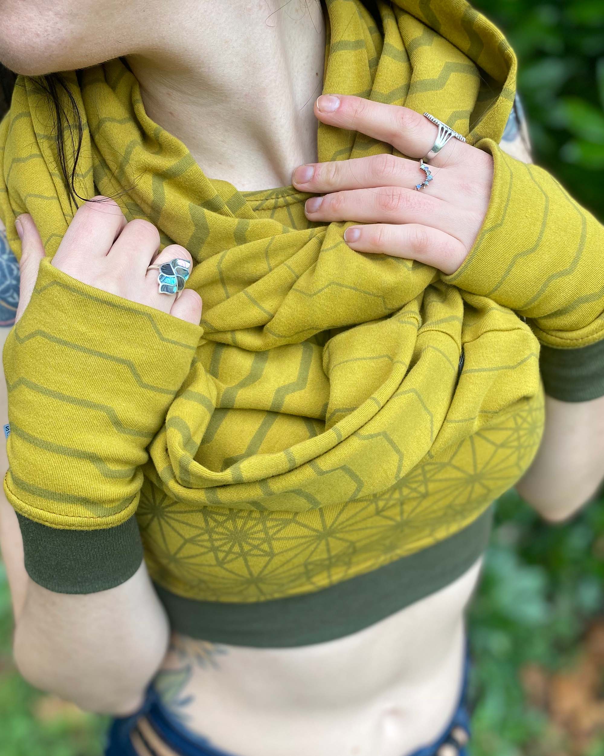 Organic cotton infinity scarf and hand warmers, yellow fabric with geometric stripes, detail view of fabric prints.