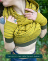 Female model wearing matching set of crop top, infinity scarf and fingerless gloves, yellow organic cotton fabric with geometric stripes, detail view.