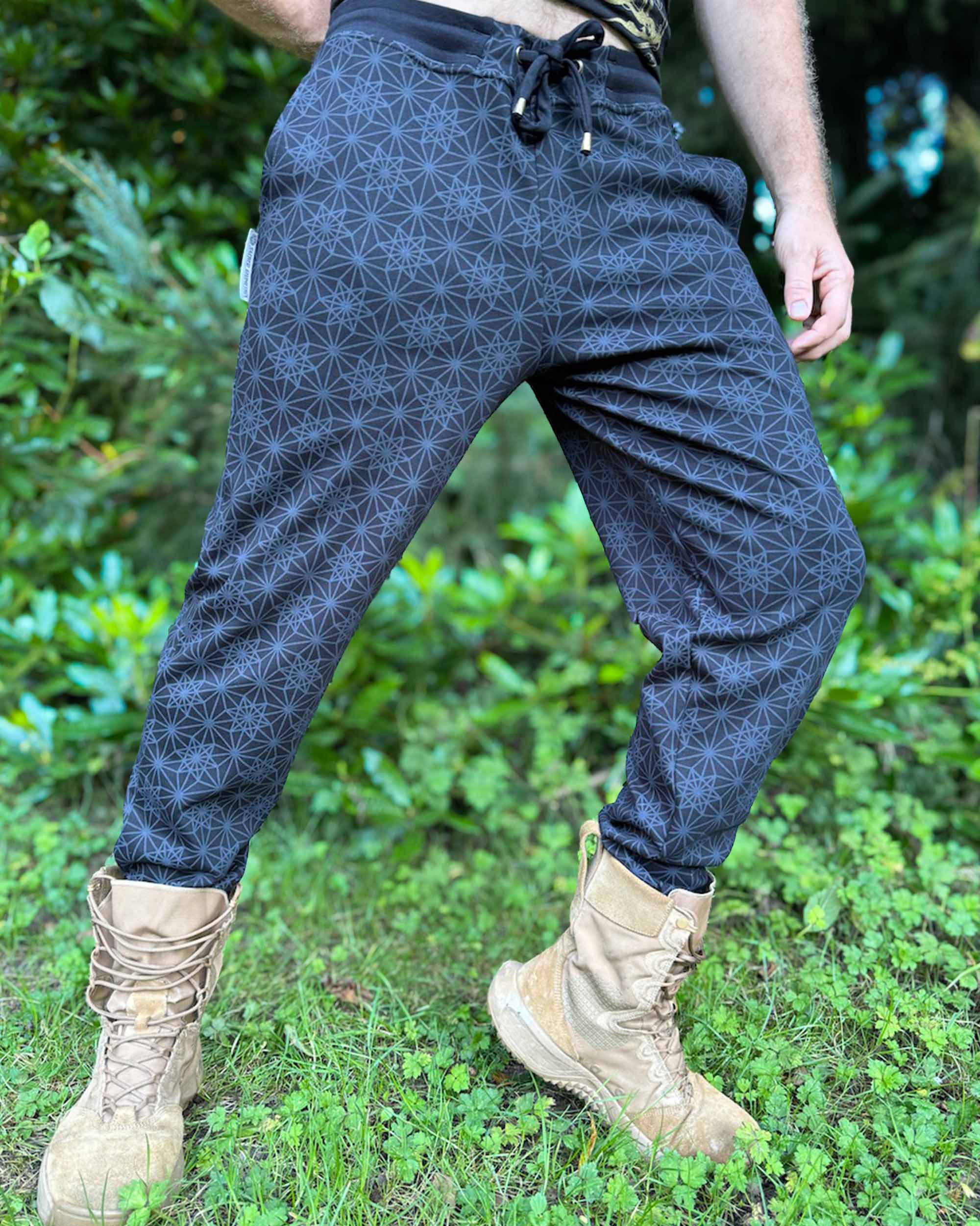Organic cotton knit joggers, black with geometric printed fabric, worn by male model.