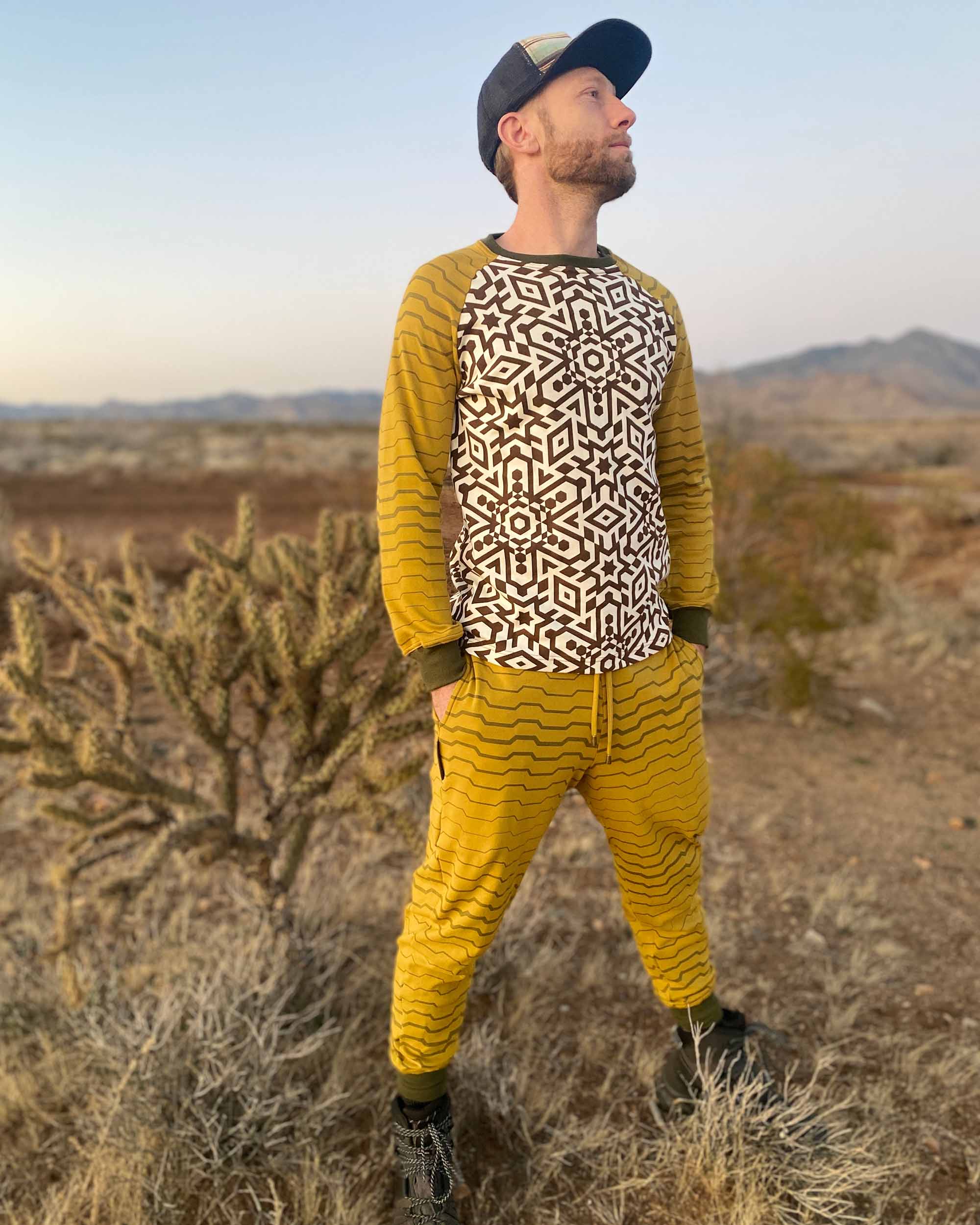 Men's matching joggers and long sleeve shirt, yellow with geometric stripe accents, worn by male model.