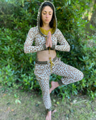 Women's matching two piece outfit, joggers and crop hoodie, undyed with brown geometric print, front view on model.