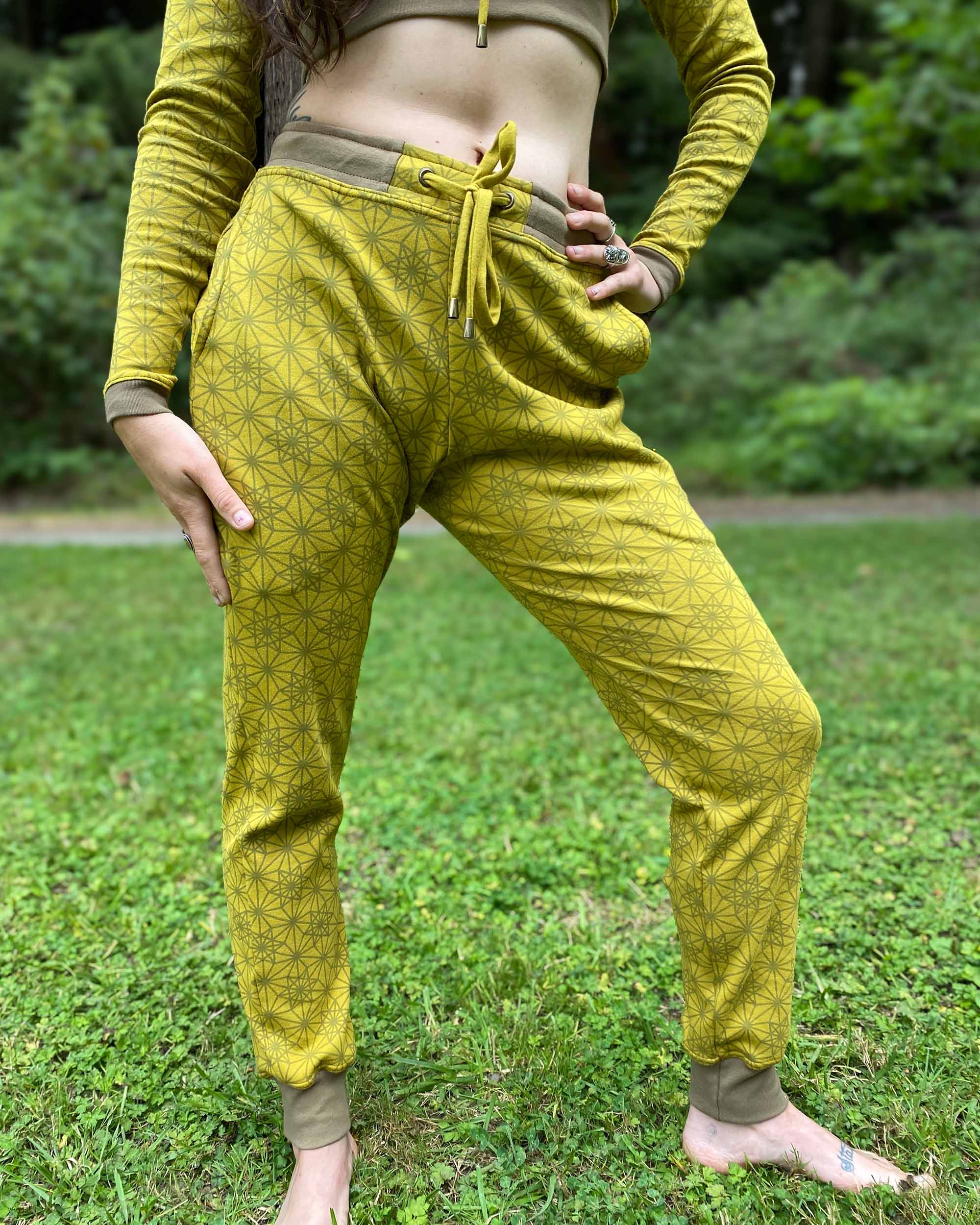 Organic cotton joggers, yellow fabric with geometric print, front length view on female model.