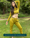Women's matching two piece outfit, joggers and crop hoodie, yellow with geometric printed fabric, full length view on model.